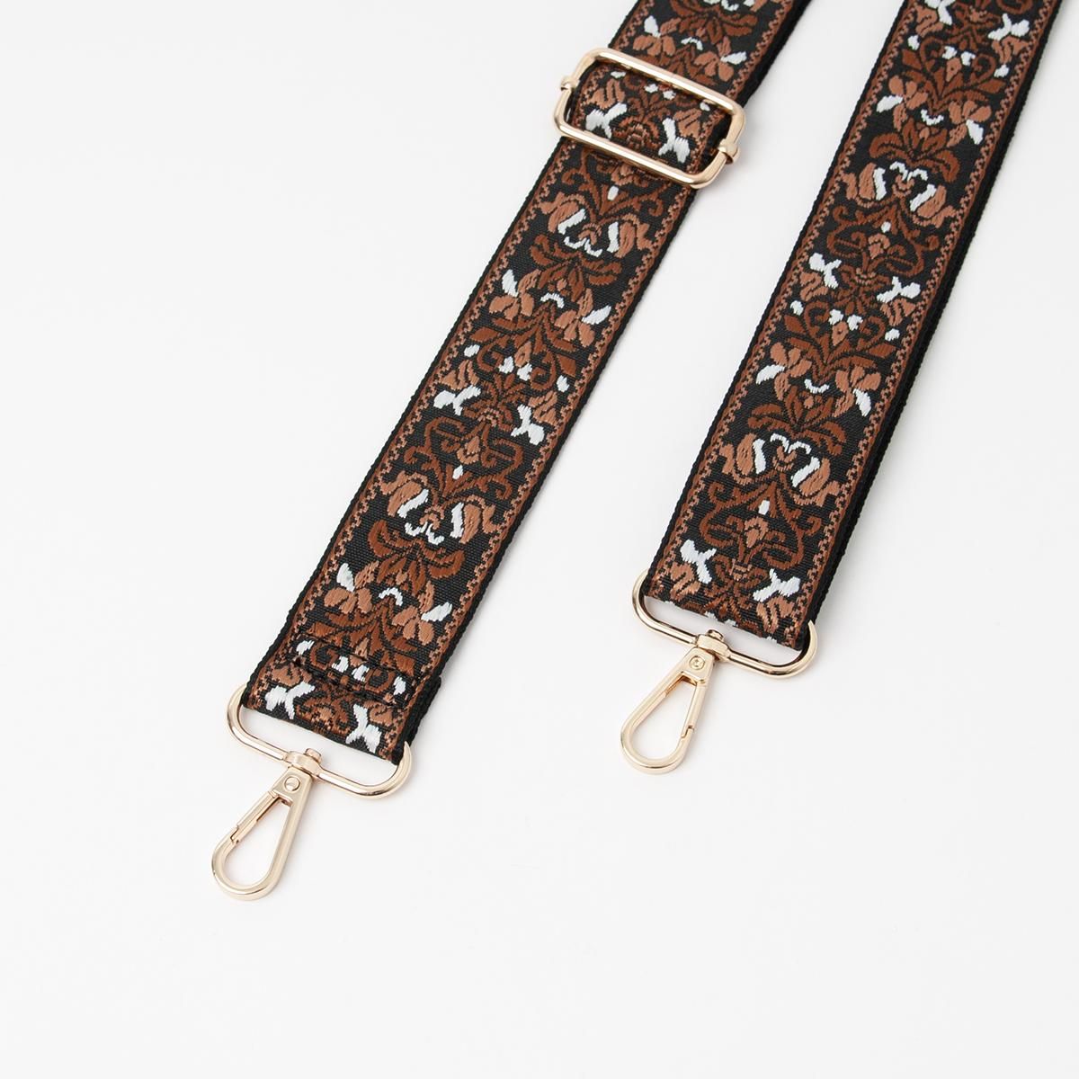 Axelrem svart och brun - bred väska rem med mönster och guldfärgad metall